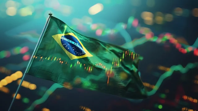 Bandeira do Brasil tremulando em primeiro plano com um gráfico de velas (candlestick) do mercado financeiro sobreposto em fundo desfocado, ilustrando o crescimento do IBC-Br janeiro.